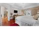 Spacious main bedroom featuring a tray ceiling, wood floors, and direct access to the pool area at 12626 Douglas Fir Ct, Clermont, FL 34711