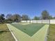 Have fun on this outdoor green basketball court surrounded by a white fence and landscaping at 12919 Freeman St, Windermere, FL 34786