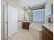 Well-lit bathroom with a shower, tub, and vanity at 12919 Freeman St, Windermere, FL 34786