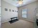 Neutral bedroom featuring a ceiling fan, window, and small workout area at 12919 Freeman St, Windermere, FL 34786