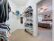 Organized walk-in closet with shelving, and a view to the main bedroom at 12919 Freeman St, Windermere, FL 34786