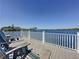 Enjoy this expansive wooden deck on a lovely lake with adirondack chairs for relaxing outdoors at 12919 Freeman St, Windermere, FL 34786