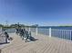 Enjoy this expansive wooden deck on a lovely lake with adirondack chairs for relaxing outdoors at 12919 Freeman St, Windermere, FL 34786