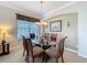 Elegant dining room with a glass-top table, seating for six, and a decorative chandelier at 12919 Freeman St, Windermere, FL 34786