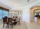 Cozy dining room featuring a glass-top table, wood chairs, and an adjacent open area at 12919 Freeman St, Windermere, FL 34786