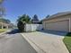 Exterior shot of the side of the home, driveway, and a peek at the pool at 12919 Freeman St, Windermere, FL 34786