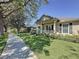 Exterior view of home showcasing a beautiful lawn, sidewalk and front porch with columns at 12919 Freeman St, Windermere, FL 34786