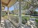 Inviting front porch with white columns, overlooking a lush green lawn and tree-lined street at 12919 Freeman St, Windermere, FL 34786