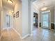 Tiled hallway with neutral paint and a view of the front door and another room at 12919 Freeman St, Windermere, FL 34786