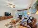 Inviting living room showcasing a leather sofa, natural light, and media cabinet at 12919 Freeman St, Windermere, FL 34786