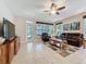 Comfortable living room featuring a brown leather sofa, entertainment center, and natural light at 12919 Freeman St, Windermere, FL 34786