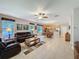 Open-concept living room with tile flooring, ceiling fan and view into the kitchen area at 12919 Freeman St, Windermere, FL 34786