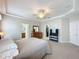 Bright main bedroom featuring a tray ceiling, carpeted floors, and ensuite bathroom access at 12919 Freeman St, Windermere, FL 34786