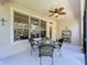 Screened patio featuring comfortable wicker seating beneath a ceiling fan at 12919 Freeman St, Windermere, FL 34786