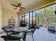 Screened patio featuring comfortable wicker seating and lush landscaping at 12919 Freeman St, Windermere, FL 34786