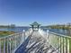 View of the community pier with a gazebo over the lake, surrounded by trees at 12919 Freeman St, Windermere, FL 34786