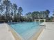 Community pool with lane lines, safety equipment, lounge chairs, and covered pergola at 12919 Freeman St, Windermere, FL 34786