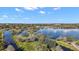 Scenic aerial view of a park and lake community with walking paths and pedestrian bridges on a sunny day at 1322 Howard Rd, Leesburg, FL 34748