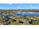 Scenic aerial view of a lake community with walking paths and pedestrian bridges on a sunny day at 1322 Howard Rd, Leesburg, FL 34748