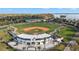 Aerial view of a well-maintained baseball field, stadium and waterfront in a recreational setting on a bright day at 1322 Howard Rd, Leesburg, FL 34748