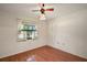 Cozy bedroom with natural light, hardwood floor, and a ceiling fan at 1322 Howard Rd, Leesburg, FL 34748