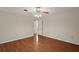 Bedroom with light walls, ceiling fan, and view to the hallway at 1322 Howard Rd, Leesburg, FL 34748