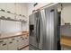 Modern stainless steel refrigerator surrounded by wood countertops and white cabinets at 1322 Howard Rd, Leesburg, FL 34748