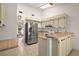 Well-lit kitchen featuring wood countertops, stainless steel refrigerator, and ample cabinet space at 1322 Howard Rd, Leesburg, FL 34748