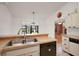 Bright kitchen view featuring wood countertops, and a serving counter overlooking the Gathering room fireplace at 1322 Howard Rd, Leesburg, FL 34748