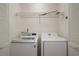 Convenient laundry area with washer, dryer, and shelving for storage at 1322 Howard Rd, Leesburg, FL 34748