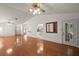 Hardwood floors, neutral walls, and a modern ceiling fan define this living space open to dining and kitchen at 1322 Howard Rd, Leesburg, FL 34748