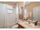 Cozy bathroom featuring a shower-tub combo, sink with dark wood vanity, and neutral colored walls at 13800 Wellington Ln, Grand Island, FL 32735