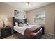 Cozy bedroom with a large window, stylish black furniture, plush carpet, and neutral color palette at 13800 Wellington Ln, Grand Island, FL 32735