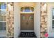 Inviting front double doors with welcome wreaths and elegant stone accents at 13800 Wellington Ln, Grand Island, FL 32735