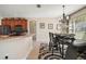 Charming breakfast nook featuring a chandelier, bar seating and adjacent kitchen with black appliances at 13800 Wellington Ln, Grand Island, FL 32735