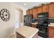 Well-lit kitchen featuring stainless appliances and an arched entryway at 13800 Wellington Ln, Grand Island, FL 32735