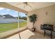 This covered lanai features tiled floor, a ceiling fan, and a view of the home's yard at 13800 Wellington Ln, Grand Island, FL 32735