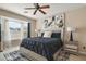 The main bedroom features a bay window, modern ceiling fan, and decorative art at 13800 Wellington Ln, Grand Island, FL 32735