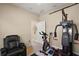 At-home fitness center with exercise bike, weight machine, leather chair, and neutral walls at 13800 Wellington Ln, Grand Island, FL 32735