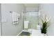 Neat bathroom featuring a glass-enclosed shower, toilet, and simple decor, providing a functional space at 1416 Lindsey Ln, The Villages, FL 32159