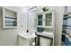 Bathroom featuring a large mirror over the sink, cabinet with storage, and blue accents at 1416 Lindsey Ln, The Villages, FL 32159