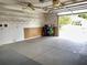 Bright, oversized garage with finished walls and overhead storage offers ample space for vehicles and projects at 1416 Lindsey Ln, The Villages, FL 32159