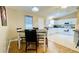 Kitchen/dining room combo featuring white cabinets and neutral colored countertops at 1416 Lindsey Ln, The Villages, FL 32159