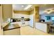 A clean, white kitchen featuring matching appliances and hard surface countertops at 1416 Lindsey Ln, The Villages, FL 32159