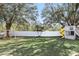 Large backyard featuring mature trees, a playground, and a privacy fence at 15912 Lake Orienta Ct, Clermont, FL 34711