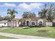 Charming single-story home with lush lawn, complemented by elegant landscaping and a welcoming entrance at 15912 Lake Orienta Ct, Clermont, FL 34711