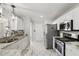 Well-lit kitchen featuring stainless steel appliances, granite countertops, and tiled backsplash at 15912 Lake Orienta Ct, Clermont, FL 34711