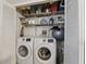 Laundry room featuring a large capacity washer and dryer, plus ample storage space at 15912 Lake Orienta Ct, Clermont, FL 34711