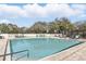 Sparkling community pool with ample lounge seating for relaxation and enjoyment at 15912 Lake Orienta Ct, Clermont, FL 34711