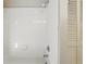 Bright shower with white tiled walls, chrome shower head, and a built in soap dish at 15912 Lake Orienta Ct, Clermont, FL 34711